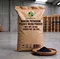 X-HUMATE 20kg mineral potassium fulvate micro powder organic fertilizer in eco-friendly kraft paper bag with clear English marks, featured with black micro powder in a wooden bowl.